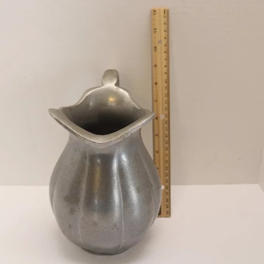 A Heavy Pewter Water Pitcher Pre Owner with some signs of wear